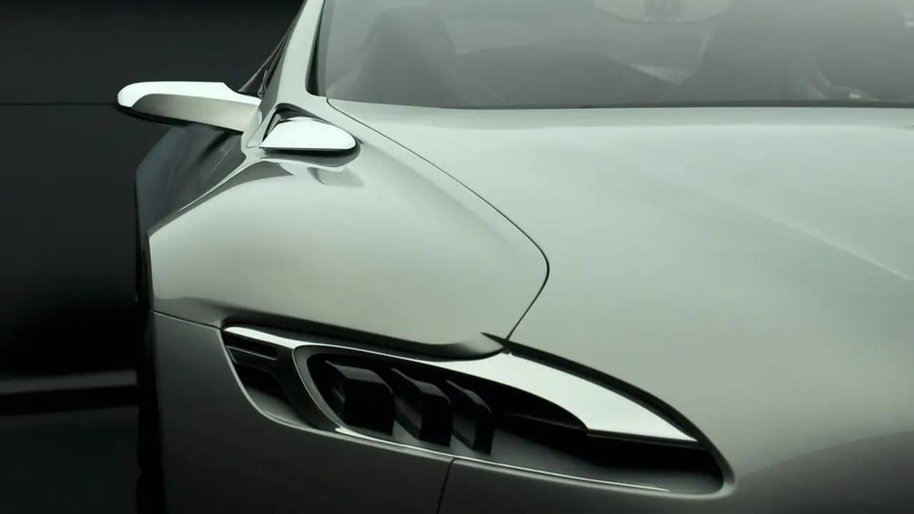 Sleek silver car with a reflective finish against a dark background